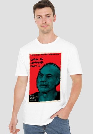 White t-shirt featuring graphic print of a character's face in blue on a red background, with text referencing "Star Trek: The Next Generation."