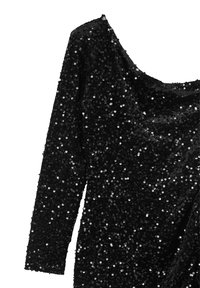 Robe noire à manches longues recouverte de sequins, dotée d'un décolleté en forme de bateau et d'un design drapé, mettant en valeur la texture et l'éclat.