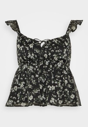 Μαύρη floral μπλούζα με ρυπαντούμενους ιμάντες, με σχέδιο δέσιμο στο μπροστινό μέρος, συγκεντρωμένη μέση και μια διαφανή, ελαφριά ύφασμα διακοσμημένη με πράσινα και άσπρα λουλούδια.