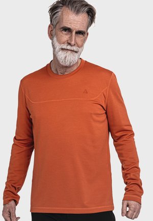 Langärmliges Shirt aus leuchtend orangefarbenem Stoff, mit einem strukturierten Muster, rundem Ausschnitt und dezenten Details auf der Brust.