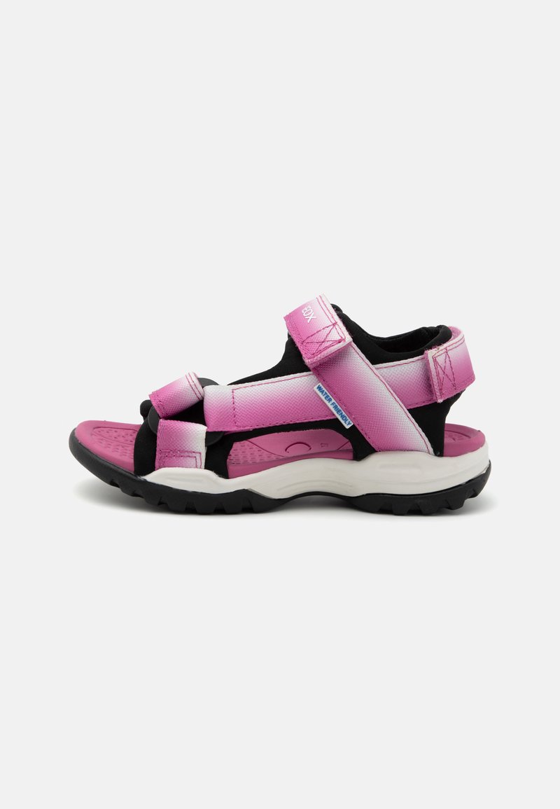 Sport sandals with pink and black nylon upper, adjustable straps, cushioned footbed, textured sole, and raised rubber tread for grip.