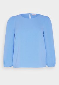 Blusa azzurra chiara con maniche lunghe a sbuffo, scollatura rotonda e un piccolo aperture sul retro. Realizzata in tessuto leggero e morbido.