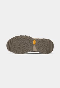Utendørssåle med en solid, teksturert brun gummiblanding, med Vibram-logo og trekantet mønster for bedre grep.
