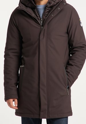 Brown insulated jacket with a high collar, zip and snap closure, side pockets, and subtle logo detail on the sleeve. Smooth texture.