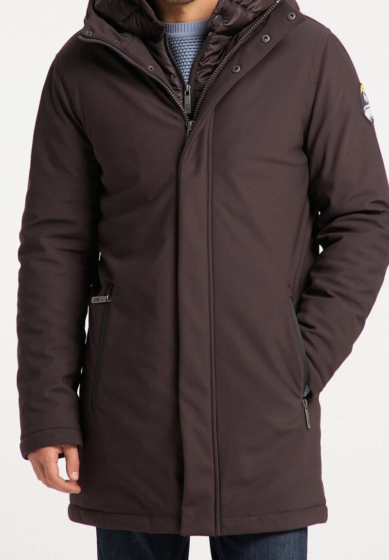 Brown insulated jacket with a high collar, zip and snap closure, side pockets, and subtle logo detail on the sleeve. Smooth texture.