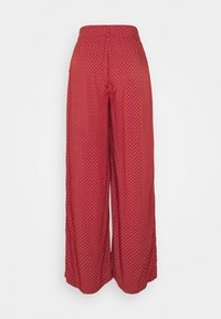 Rote weit geschnittene Hose mit einem strukturierten Rautenmuster. Der elastische Bund sorgt für Komfort. Das Material ist leicht und fließend, ideal für warmes Wetter.