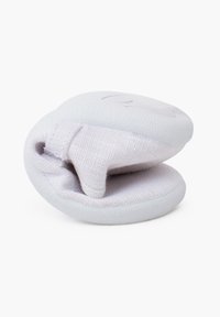 Materiale in silicone morbido e bianco con rivestimento interno in tessuto. Forma arrotondata e flessibile, caratterizzata da una texture liscia e un design minimalista.