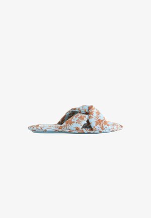 Light blue flat slide sandal with brown floral print and wide twisted fabric strap across the top.