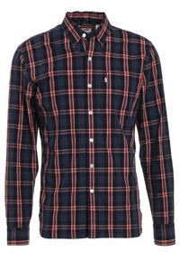 Camicia a maniche lunghe a quadri in blu navy, rosso e bianco. Presenta chiusura con bottoni, una tasca sul petto e un colletto tradizionale. Materiale in cotone.