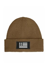 Brown knitted beanie with a ribbed texture and a black rectangular patch featuring a white flag design.