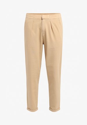 Pantalons décontractés beiges avec plis, taille élastique, jambe fuselée et ourlets roulés ; fabriqués en tissu léger et doux.