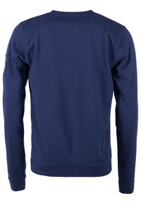 Mörkblå långärmad sweatshirt i bomullsmaterial, med ribbade ärmslut och nederkant, har en liten dekorativ lapp på vänster ärm.