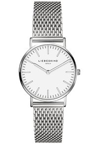 Ronde zilveren horloge met een witte wijzerplaat, minimalistische zwarte uurmarkeringen en een mesh roestvrijstalen band. Beschikt over een eenvoudige kroon voor aanpassingen.
