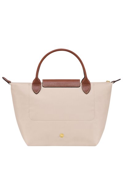 Beige tote bag with brown leather handles and accent. Features a magnetic closure and front pocket. Smooth texture with contrasting leather.