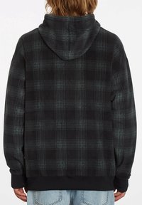 Sudadera con capucha de cuadros en negro y gris, con una textura suave, una capucha grande y puños acanalados. Presenta un ajuste holgado y está hecha de material polar.