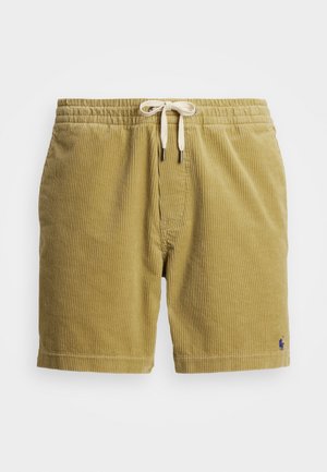 Corduroy shorts in mustard yellow with a textured surface, elastic waistband, and cream drawstring. Features a small blue logo accent.