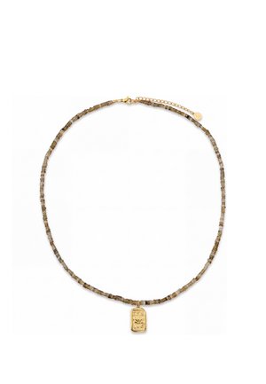 Necklace with small neutral-toned cylindrical beads and a rectangular gold pendant featuring floral and crescent moon engravings.