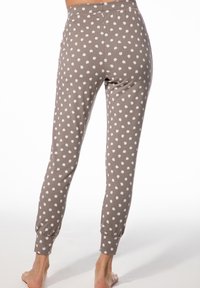 Braune Jogginghosen aus weichem Stoff, mit einem weißen Tupfenmuster, elastischen Bündchen und einem bequemen Bund.