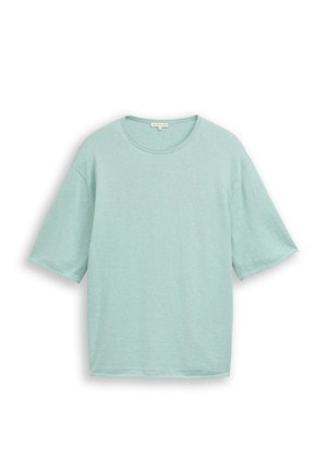 Jasnoniebieski, oversize, krótki rękaw, t-shirt z okrągłym dekoltem, wyłożony na płasko na białym tle.