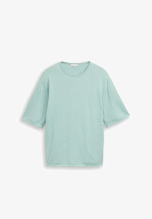 Lichtblauw oversized T-shirt met korte mouwen en een ronde hals, plat liggend afgebeeld op een witte achtergrond.