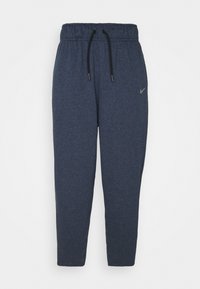 Marina blå sweatpants gjorda av mjukt tyg, med elastisk midja och svart dragsko, samt en liten logotyp på vänstra låret.