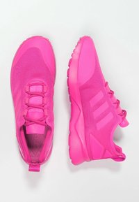 Bright pink athletic shoes with mesh fabric, rubber soles, and three accent stripes. Features laces and a pull tab at the heel.