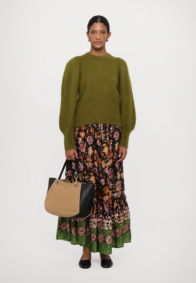 Olive green fluffy sweater, black floral tiered skirt with green hem, paired with a black and woven bag, and black flat shoes.