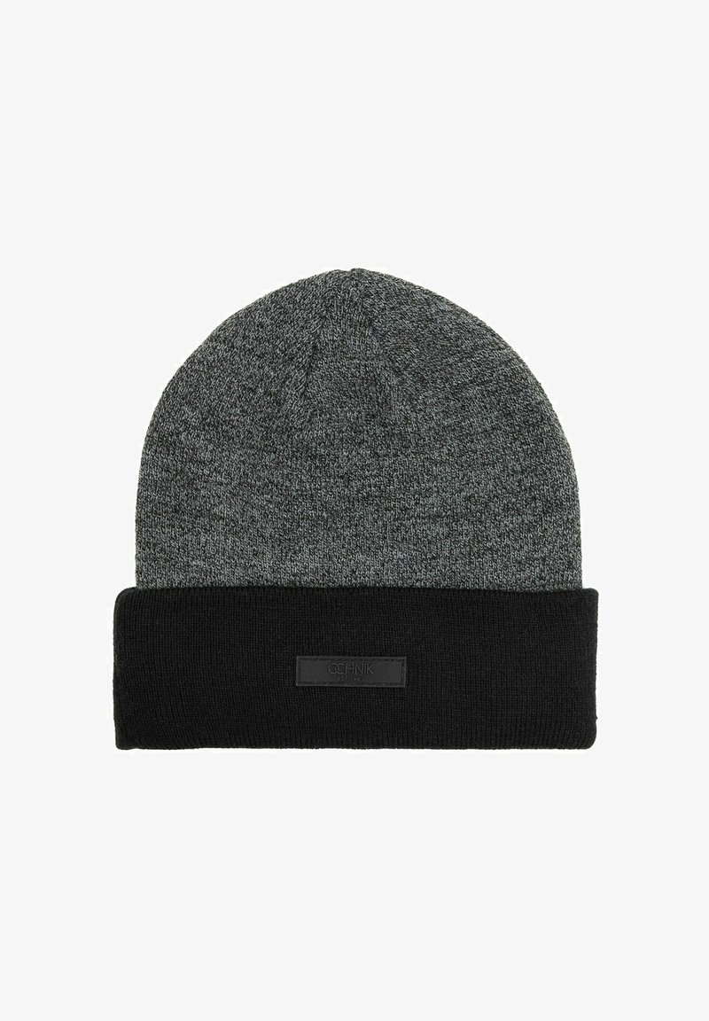 Szary dzianinowy beanie z czarnym zgięciem i małą prostokątną czarną metką na zgięciu.