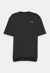 T-shirt en coton noir avec un col rond, des manches courtes et un ourlet arrondi. Présente un logo imprimé en blanc et bleu sur la poitrine.