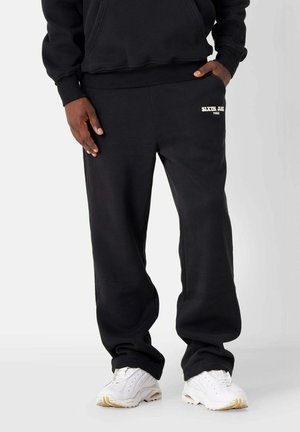 RETRO - Tracksuit bottoms - black