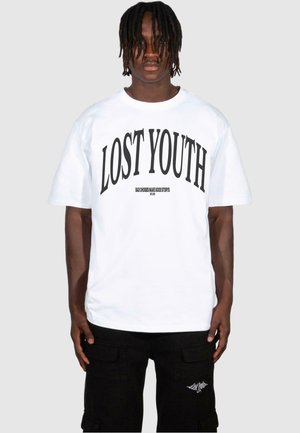 White short-sleeve T-shirt with bold black text "LOST YOUTH" and smaller text below. Worn with black cargo shorts featuring pockets.