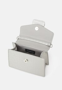 Silver faux leather wallet with a croc-embossed texture. Features a snap closure and one main compartment with a brand label visible inside.