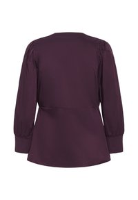 Bluza bordo cu mâneci lungi, bufante, decolteu rotund și un design cu talie strânsă. Material neted cu o strălucire subtilă.