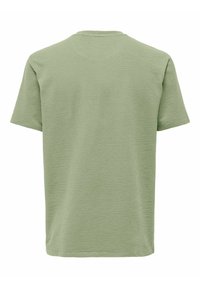 Kortærmet t-shirt i lys grøn, struktureret stof med et ensartet design. Rund hals uden synlige detaljer eller accenter.