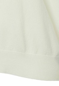 Light cream knit sweater with a ribbed hem. The fabric has a soft texture and subtle pattern, showcasing a smooth finish and relaxed fit.