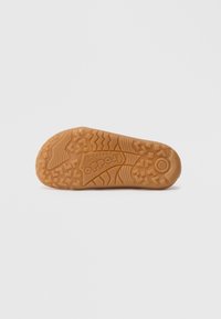 Brown rubber sole with textured pattern, featuring a logo and sizing detail, designed for grip and durability.