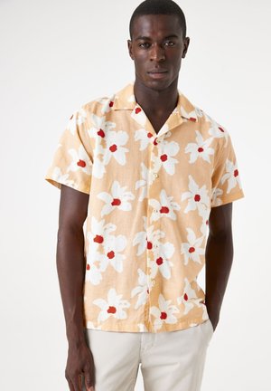 Short-sleeved, button-up shirt in light yellow with large white and red floral pattern, cotton fabric, relaxed fit, notched collar.