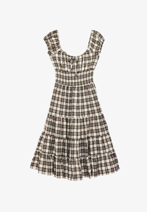 Robe à carreaux marron et blanche avec manches courtes bouffantes, taille smockée, jupe à volants et détail noué au niveau de l’encolure.