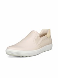 Chaussures beige clair à enfiler en cuir lisse avec des panneaux latéraux élastiques et une semelle en caoutchouc blanche dotée d'un motif antidérapant texturé.