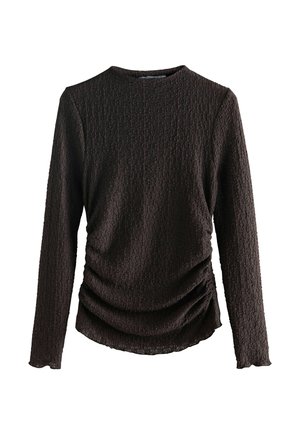 Brown long-sleeve top with textured fabric, featuring a round neckline and gathered detailing at the sides for a fitted look.