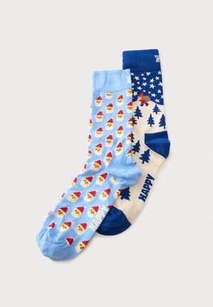 Paire de chaussettes colorées sur le thème de Noël, une bleu clair avec des visages du Père Noël, une blanche et bleue avec des arbres, des étoiles et un motif de renne.