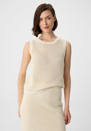 Cream mesh sleeveless top with a ribbed neck and hem, featuring an open knit pattern and relaxed fit. Paired with a matching skirt.