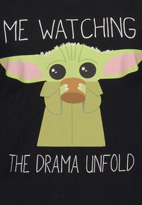 Black T-shirt featuring a cartoon character with large ears and eyes, holding a cup; text reads “ME WATCHING THE DRAMA UNFOLD.”