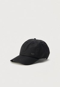 Black baseball cap with curved brim, small "BOSS" logo on front, and stitched panel design on a plain light background.