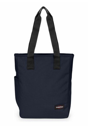 Navy blue Eastpak tote bag with black straps, rectangular shape, side pocket, and branded logo patch on the lower front.