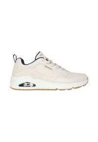 Zapatilla Skechers de cuero beige con acentos en azul marino. Cuenta con una suela acolchada, diseño con cordones y una unidad de aire visible en el talón.