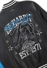 Black leather jacket with embroidered panther, stars, rose, and text "Ed Hardy," "Drawn by Ed," "San Diego," and "Est. 1971" on back.