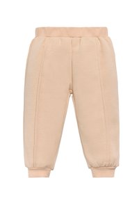 Pantalones de chándal beige claro con una cinturilla elástica, dobladillos ajustados y costuras verticales en la parte delantera. Tejido suave con una textura lisa.