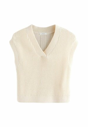 Gilet tricoté sans manches couleur crème avec col en V et bord-côtes, montrant un motif de point texturé et une étiquette de marque à l'intérieur du col.