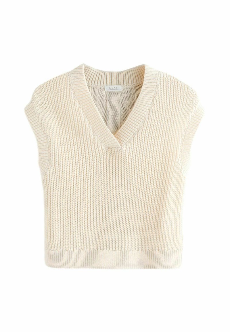 Gilet tricoté sans manches couleur crème avec col en V et bord-côtes, montrant un motif de point texturé et une étiquette de marque à l'intérieur du col.